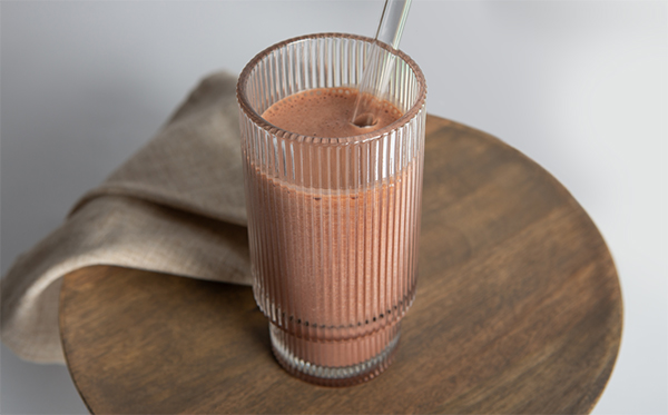 chocolate smoothie meal replacement in a glass with a straw
