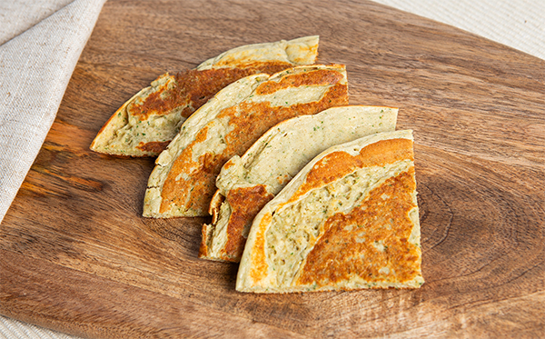 VLCD garlic flatbreadcut on a wooden choppign board