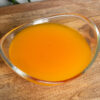 orange and mango jelly mix in a glass bowl