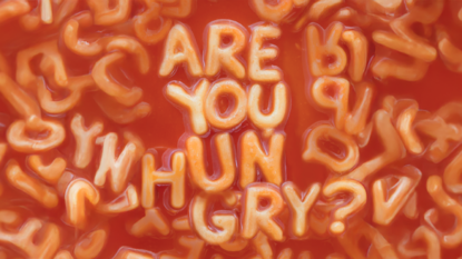 Photo of spaghetti in tomato sauce spelling out the words 'Are you Hungry'.