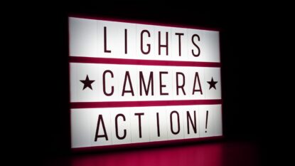 Light box with the words Lights, Camera, Action on it.
