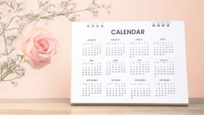 Pink background with a desk calendar on it.